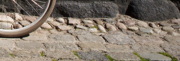 Wheel and bumpy cobblestones.
