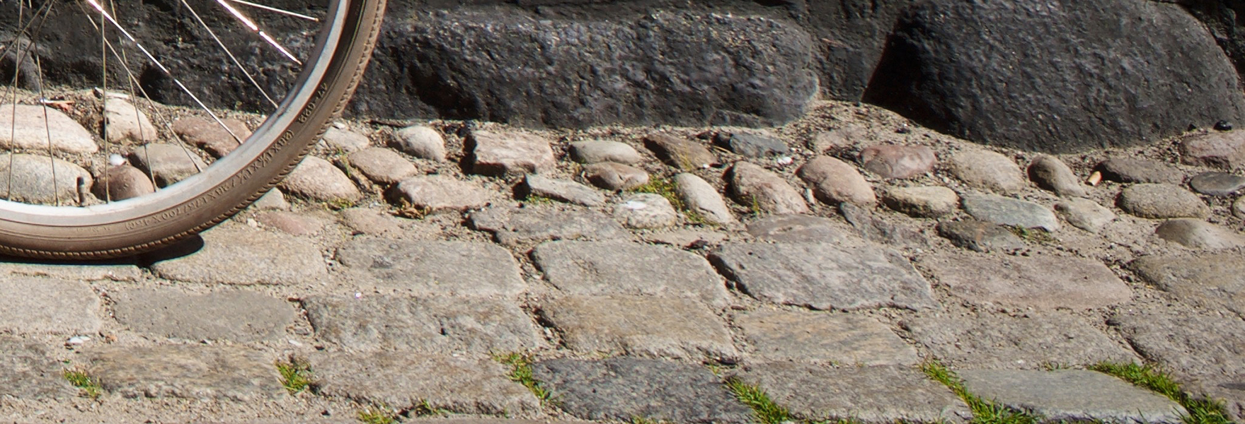 Wheel and bumpy cobblestones.