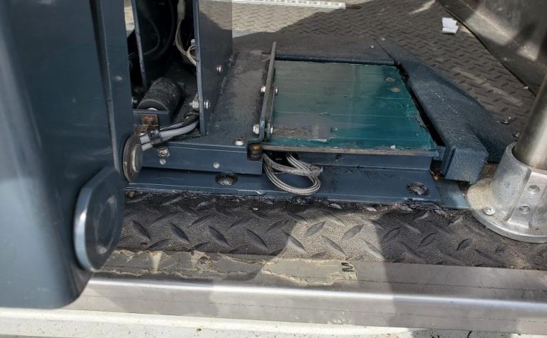 Defective VMI Ricon Slide-Away Wheelchair Lift with wires sticking out in need of repair.